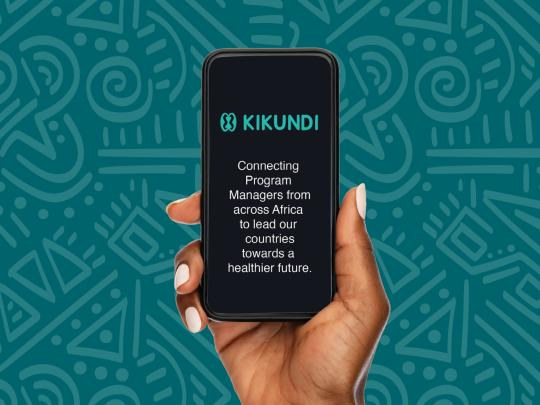 Image of the cover of the 2023 Kikundi Annual Report. A teal background with a patterned overlay, and a hand holding up a mobile phone.
